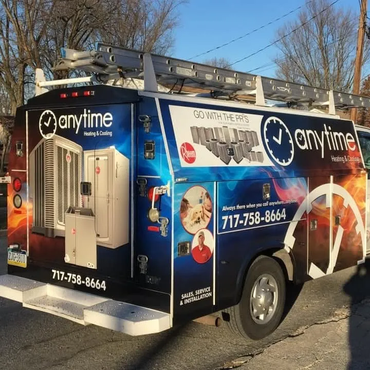 The Anytime Heating & Cooling service truck, wrapped with the company logo and phone number